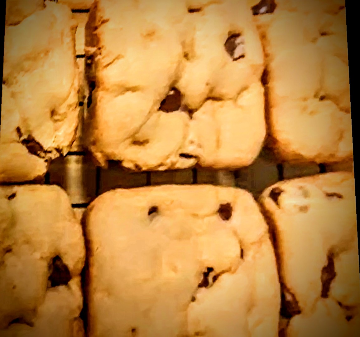 Freshly baked chocolate chip cookies on a cooling rack